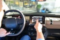 man operates navigation device in car in a car dealership and tests it Royalty Free Stock Photo