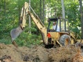 Man operating backhoe