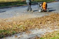 Man operating cleaning the sidewalk with a leaf blower Royalty Free Stock Photo