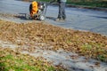 Man operating cleaning the sidewalk with a leaf blower Royalty Free Stock Photo
