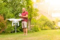 Man operating a drone with remote control - happy guy playing with a quadricopter in the garden Royalty Free Stock Photo