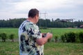 A man operating the drone by remote control on the meadow Royalty Free Stock Photo