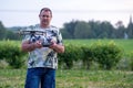 A man operating the drone by remote control on the meadow near forest Royalty Free Stock Photo