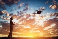 Man operating a drone at sunset. Royalty Free Stock Photo