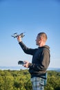 Man operating drone using remote controller. Royalty Free Stock Photo