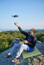 Man operating drone using remote controller. Royalty Free Stock Photo