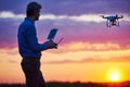 Man operating of flying drone at sunset Royalty Free Stock Photo