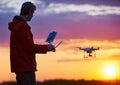 Man operating of flying drone at sunset Royalty Free Stock Photo