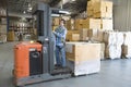 Man Operating Forklift Truck In Warehouse