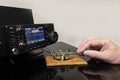 Man operating morse code key with modern radio transceiver Royalty Free Stock Photo