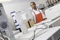 Man operating printing machine at press