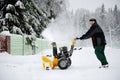 A man operating snow blower Royalty Free Stock Photo