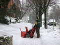 Man operating snow blower to clear driveway Royalty Free Stock Photo