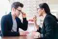 Man in optician shop getting advice from saleswoman