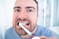 Man and oral hygiene routine using electric toothbrush Royalty Free Stock Photo