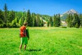 Man with orange backpack and mountain peaks Royalty Free Stock Photo