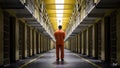 A man in orange jumpsuit standing alone inside a jail cell, AI Royalty Free Stock Photo