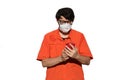 Man with orange shirt and surgical mask while using smarthpone t