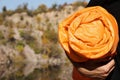 Man with orange sleeping bag outdoors, closeup.