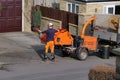 Man feeding tree shredder chipper