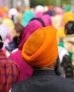 man with orange turban and thick beard during the event