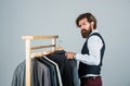 Man ordering business suit posing indoor. Tailor measures man. stylish man at workspace. Fashion design studio. Male