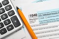 A man organizing individual income tax return form 1040 and receipts. Blurred background. Tax time.Tax concept. Close-up