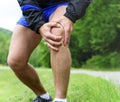 Man out jogging with knee pain Royalty Free Stock Photo