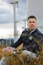 man. Outdoor male portrait over landscape with wind turbines Royalty Free Stock Photo