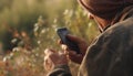 A man outdoors, holding a mobile phone, texting and working generated by AI Royalty Free Stock Photo