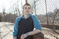 Man outside close to a fence without feeling Royalty Free Stock Photo