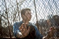 Man outside close to a fence without feeling Royalty Free Stock Photo