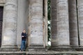 A man outsized by huge pillars of an ancient structure. Royalty Free Stock Photo