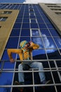 Man in overalls on background glassed building Royalty Free Stock Photo