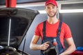 Man in overalls with canister in his hands