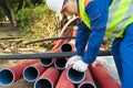 A man in overalls checks red pipes for marriage Royalty Free Stock Photo