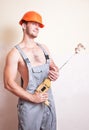 Man in overalls with a mixer for plastering Royalty Free Stock Photo