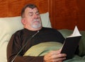 Man with Oxygen Cannula Reading in Bed