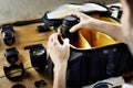 Man packing camera lens to his bag Royalty Free Stock Photo