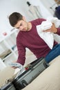 Man packing clothes into travel bag to go on vacation Royalty Free Stock Photo