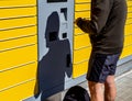 Man at a packing station picking up packages