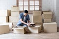 man is packing things, such as books, into boxes for relocation to new home Royalty Free Stock Photo