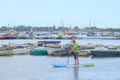 Man paddle boarding in yacht harbour