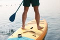 Man paddle boarding on SUP board in sea, back view Royalty Free Stock Photo