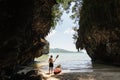Man with a paddle standing next to sea kayak at secluded beach in Krabi, Thailand Royalty Free Stock Photo