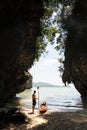 Man with a paddle standing next to sea kayak at secluded beach in Krabi, Thailand Royalty Free Stock Photo