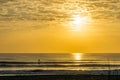 Man Paddle Surfing at Sunrise