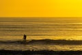 Man Paddle Surfing at Sunrise