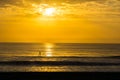 Man Paddle Surfing at Sunrise