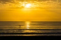 Man Paddle Surfing at Sunrise